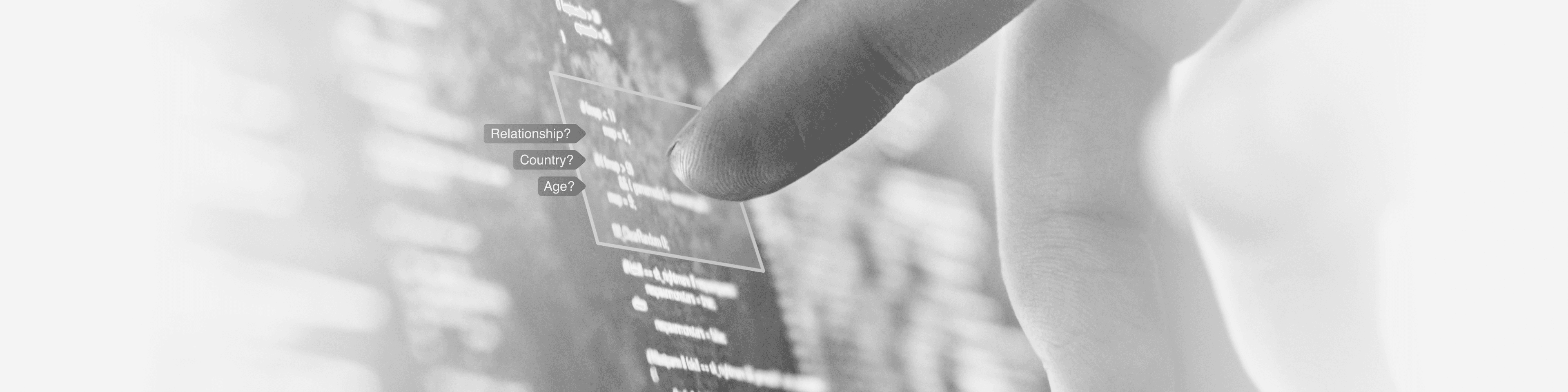 A composite photo of a finger pointing at a computer screen, with the questions "Relationship?", "Country?" and "Age?" overlayed as text. It represents a human annotating or labeling data to train artificial intelligence and advance machine learning.